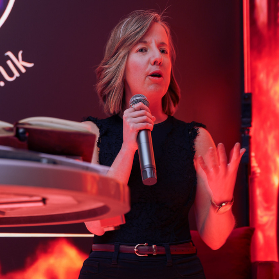 Lady Velvet speaking on stage at Velvet After Dark London erotic spoken word event